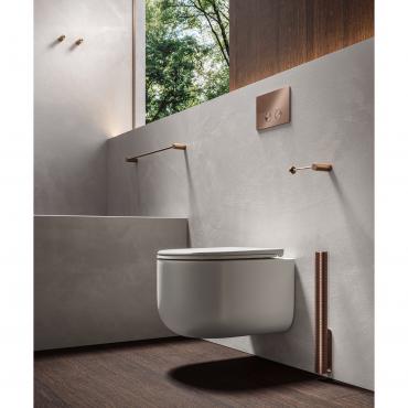 Wall-mounted Filo toilet brush with Graffiti texture beside a wall-hung toilet, matching the flush plate, toilet roll holder, towel rail and wall hooks.